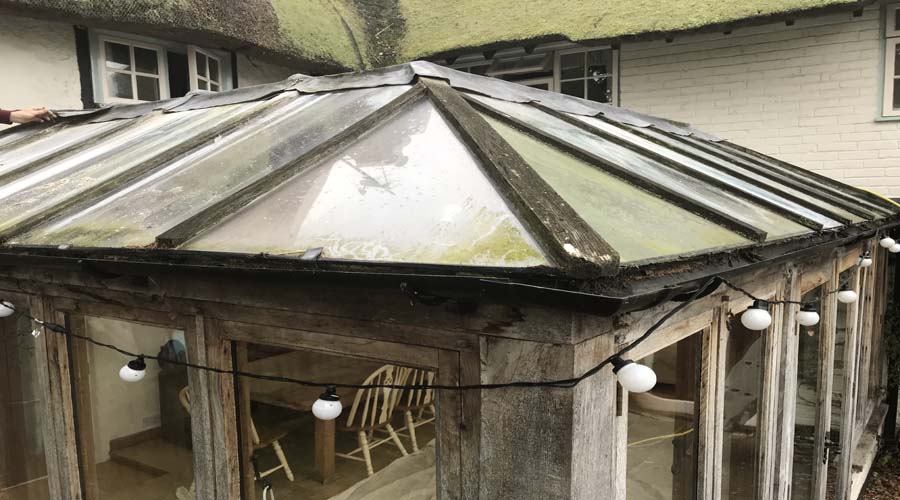 Dirty algae stained conservatory roof